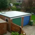 roof installations on a red bricked garage
